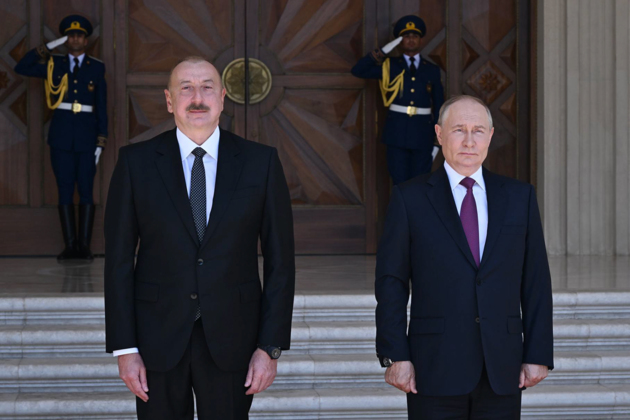 Vladimir Putin and Ilham Aliyev greet each other ahead of Beijing parade