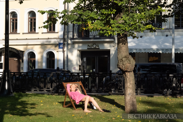 A woman on a boulevard in a deck chair