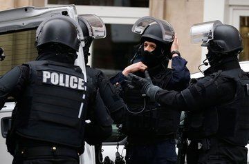 Hostage taker surrenders outside French bank
