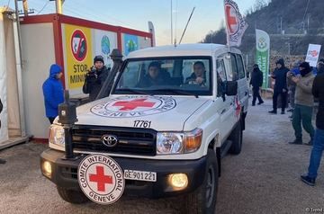 Red Cross vehicles transport severely ill people along Azerbaijan's Lachin road