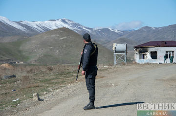 Azerbaijanis give water to Armenians on Lachin road in Karabakh